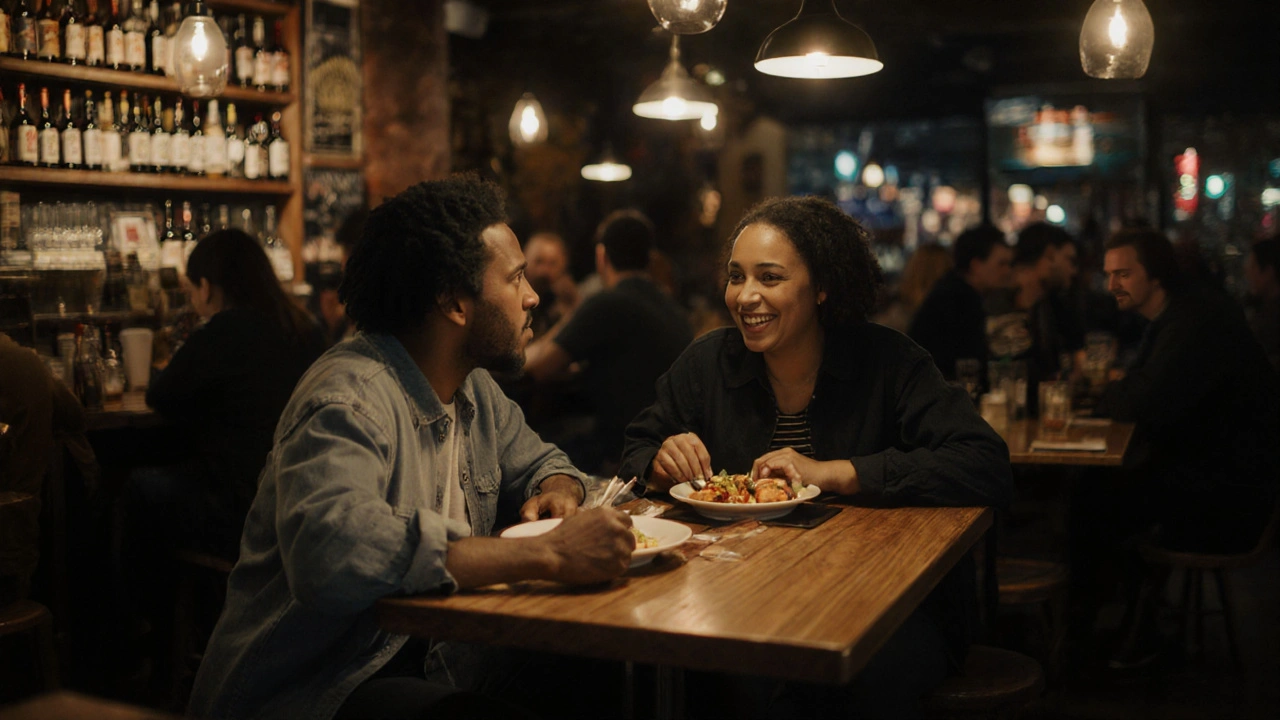 A couple sharing a meal in a cozy Stratford café, softly lit by pendant lamps, no devices visible.
