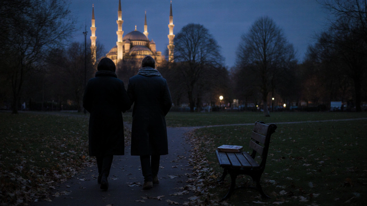 Two people walking peacefully along Victoria Park at dusk, mosque lights glowing in the distance under a twilight sky.