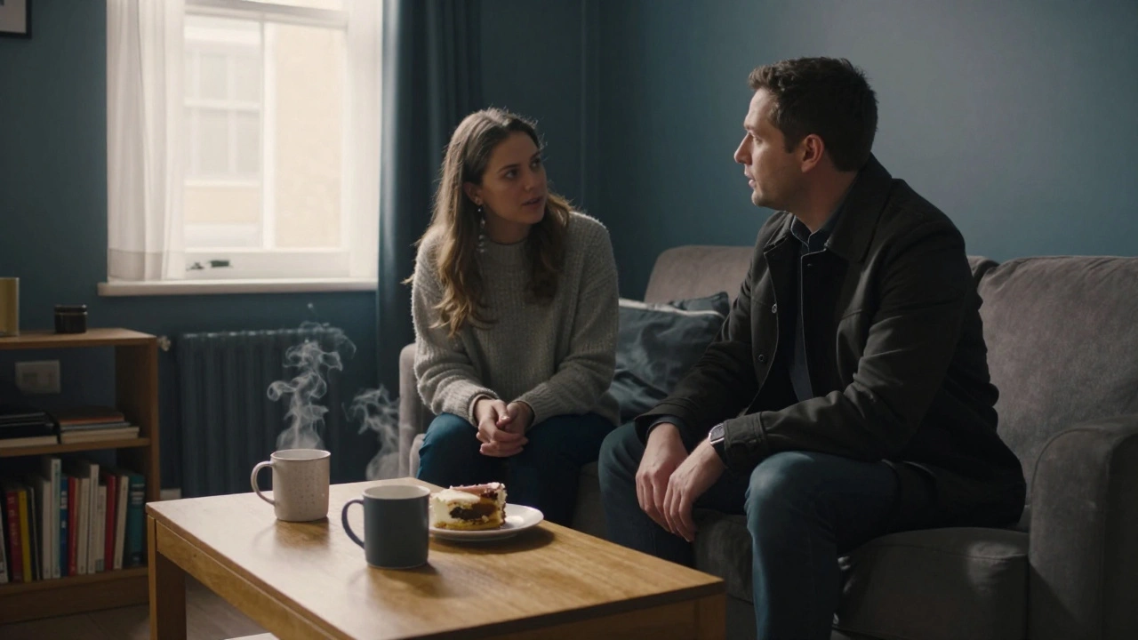 A woman listens attentively to a man in a modest flat in Cambridge Heath, two mugs on a coffee table.