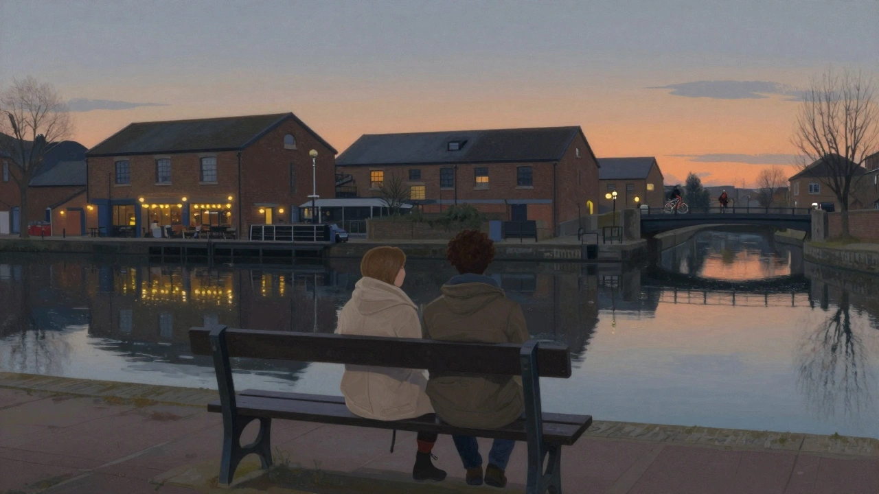 Two people sitting peacefully on a canal bench at dusk near Hackney Wick, surrounded by urban greenery.