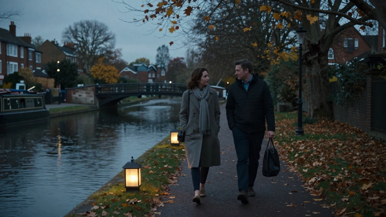 Two people walking peacefully along the Grand Union Canal at dusk, autumn leaves falling softly.