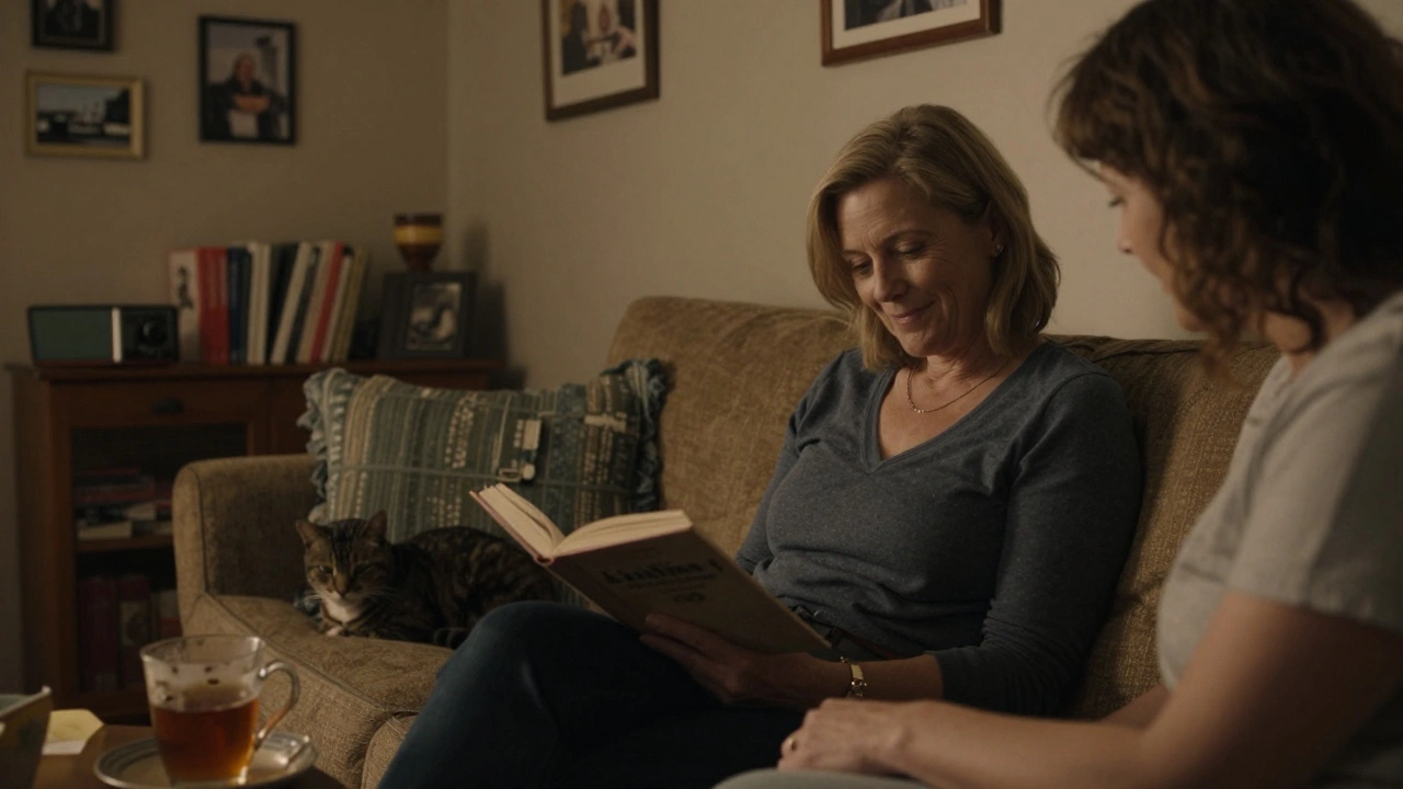 A woman reads aloud to a companion in a warm, softly lit living room in Keston, with tea and a cat nearby, conveying quiet intimacy.