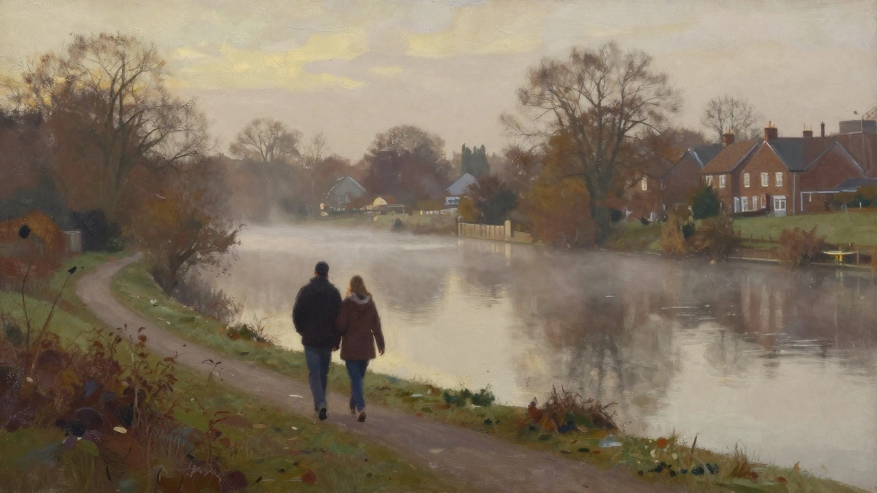 Couple walking along River Lea in Enfield with morning mist and trees.