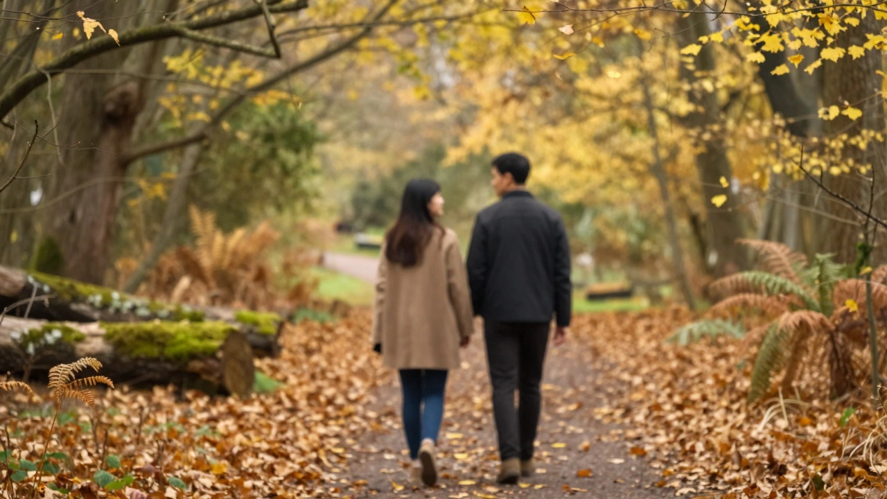 Couple walking through Sydenham Hill Wood park on autumn path.