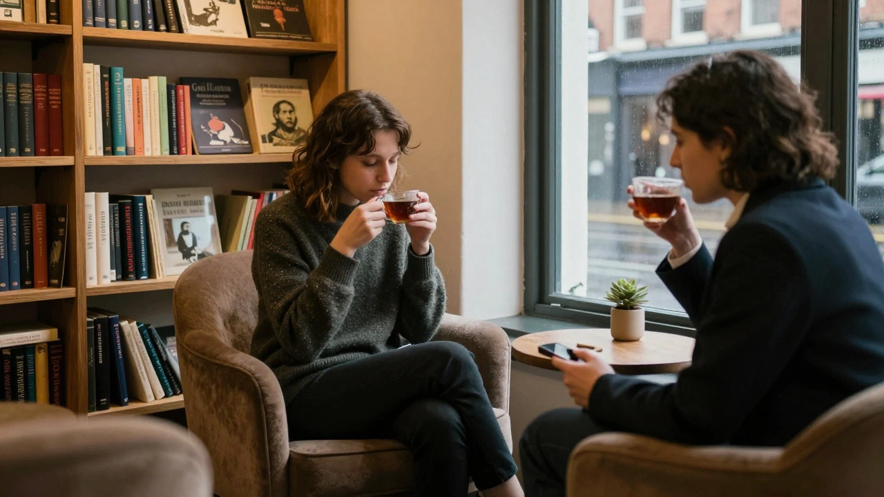 Two individuals sit quietly in a cozy lounge near Golders Green, sharing tea and conversation in a calm, screen-free setting.