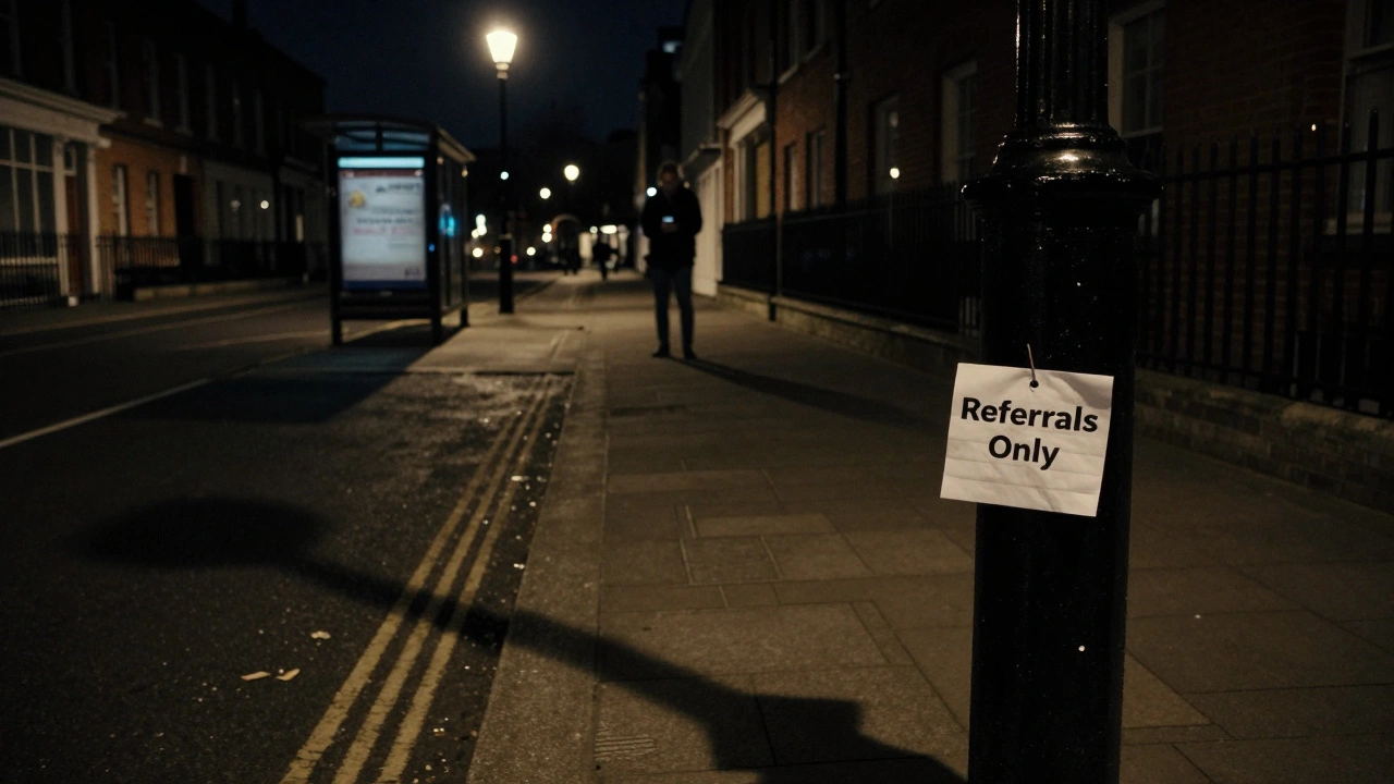 A lone streetlamp in Haringey casts a shadow over a folded note reading 'Referrals Only' at night.